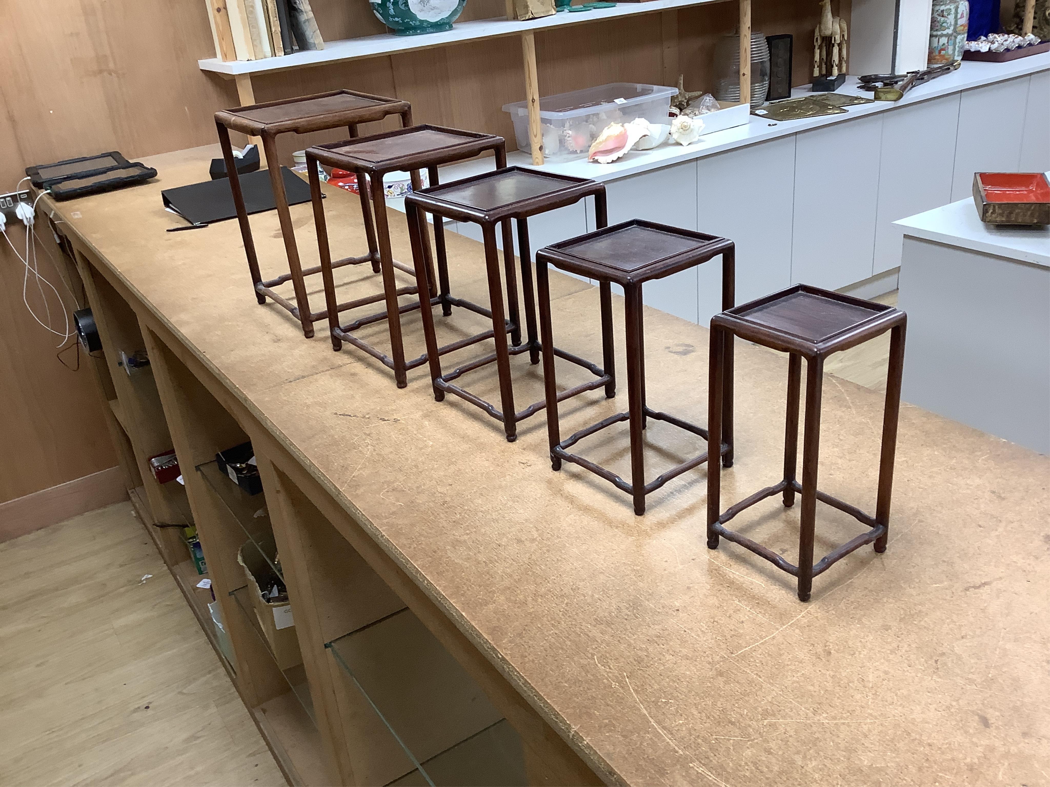 A nest of five Chinese hardwood stands, tallest (largest) 32cm high